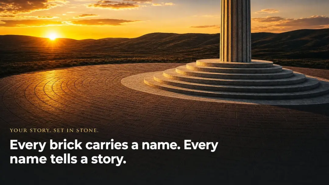 Golden sunset illuminating inscribed commemorative bricks radiating outward from the base of the Old Glory Rising monument column, each brick carrying a name and a story set in stone